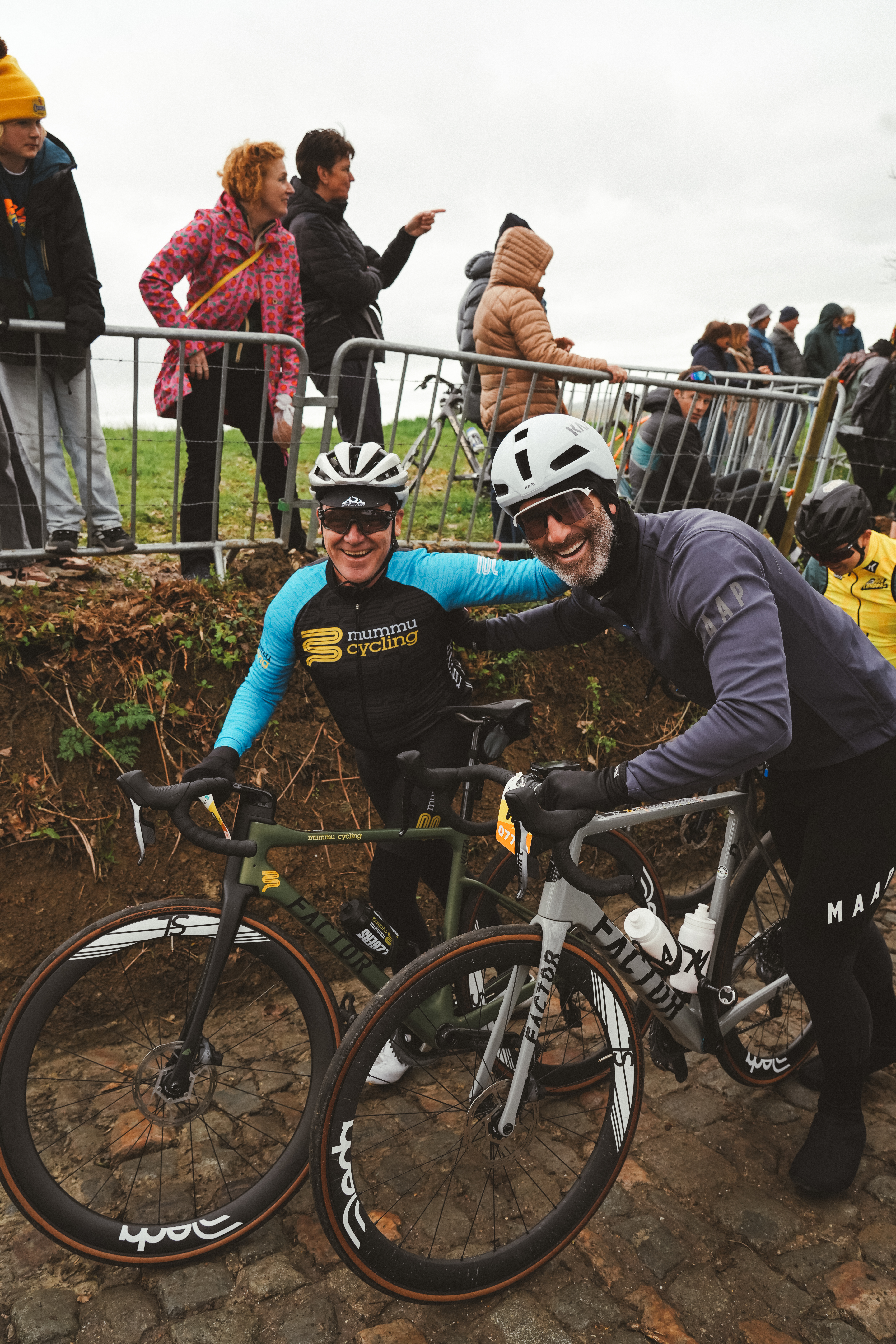 Stuart O'Grady and a Mummu Cycling guest smiling with their Factor bikes at a cycling event.