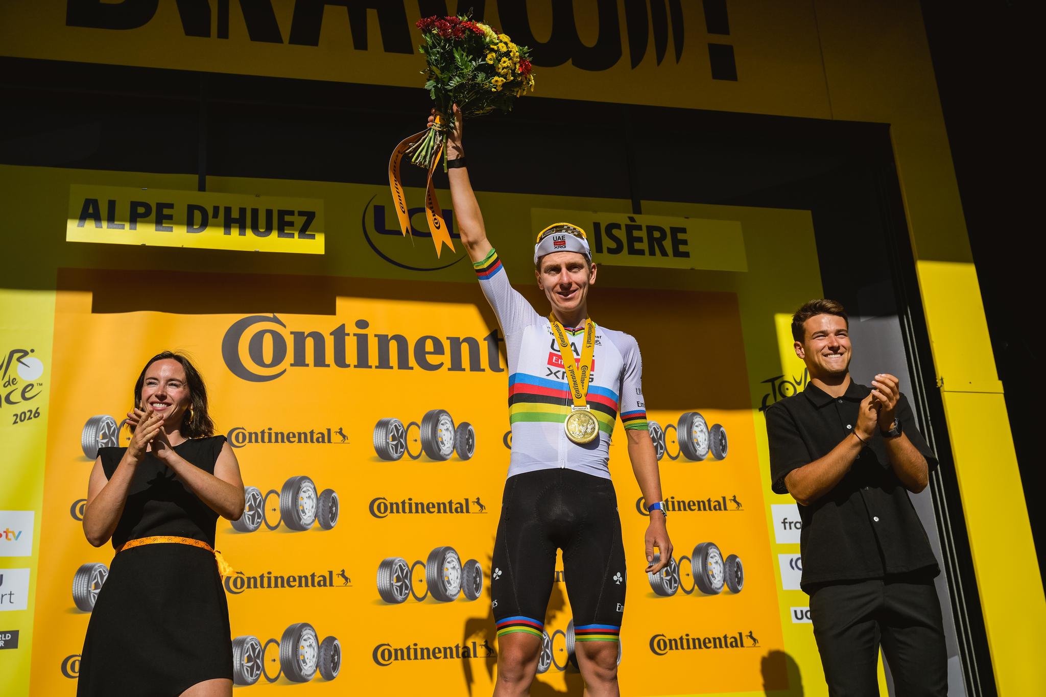Tadej Pogačar, UCI World Champion, celebrates on the podium at Alpe d'Huez after winning Stage 19 of the Tour de France 2026.