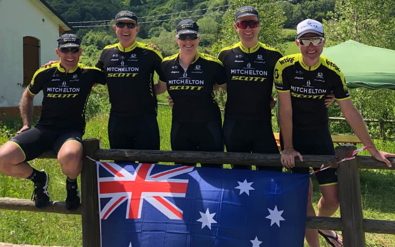 Group of cyclists in Jayco AlUla kit with Australian flag