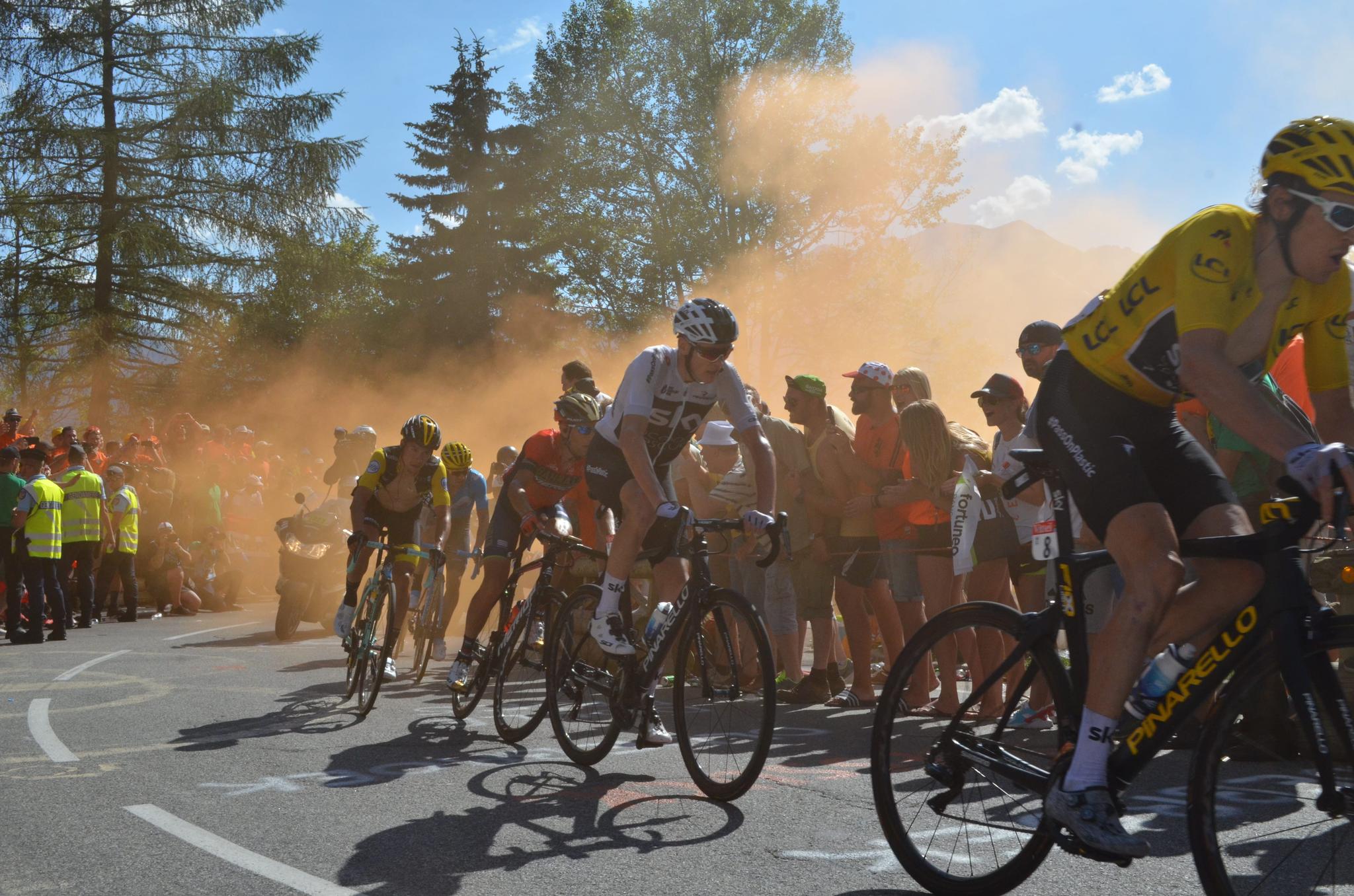 Cyclists racing through orange smoke, Tour de France