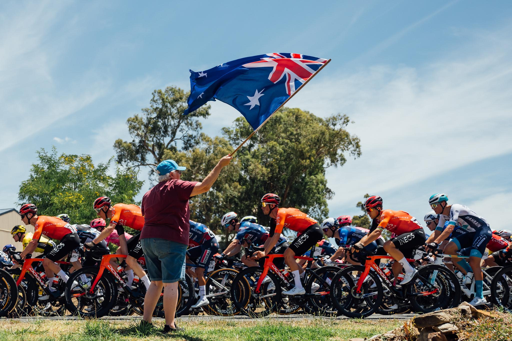 Peloton at the 2025 Tour Down Under Stage 1, Australian flag waving