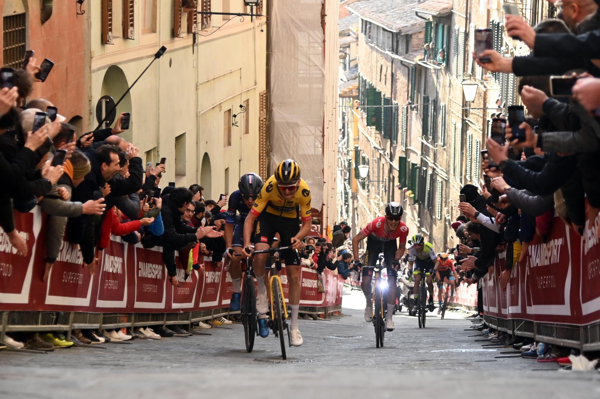 Visma-Lease a Bike rider leads uphill race in Tuscany, crowd cheering