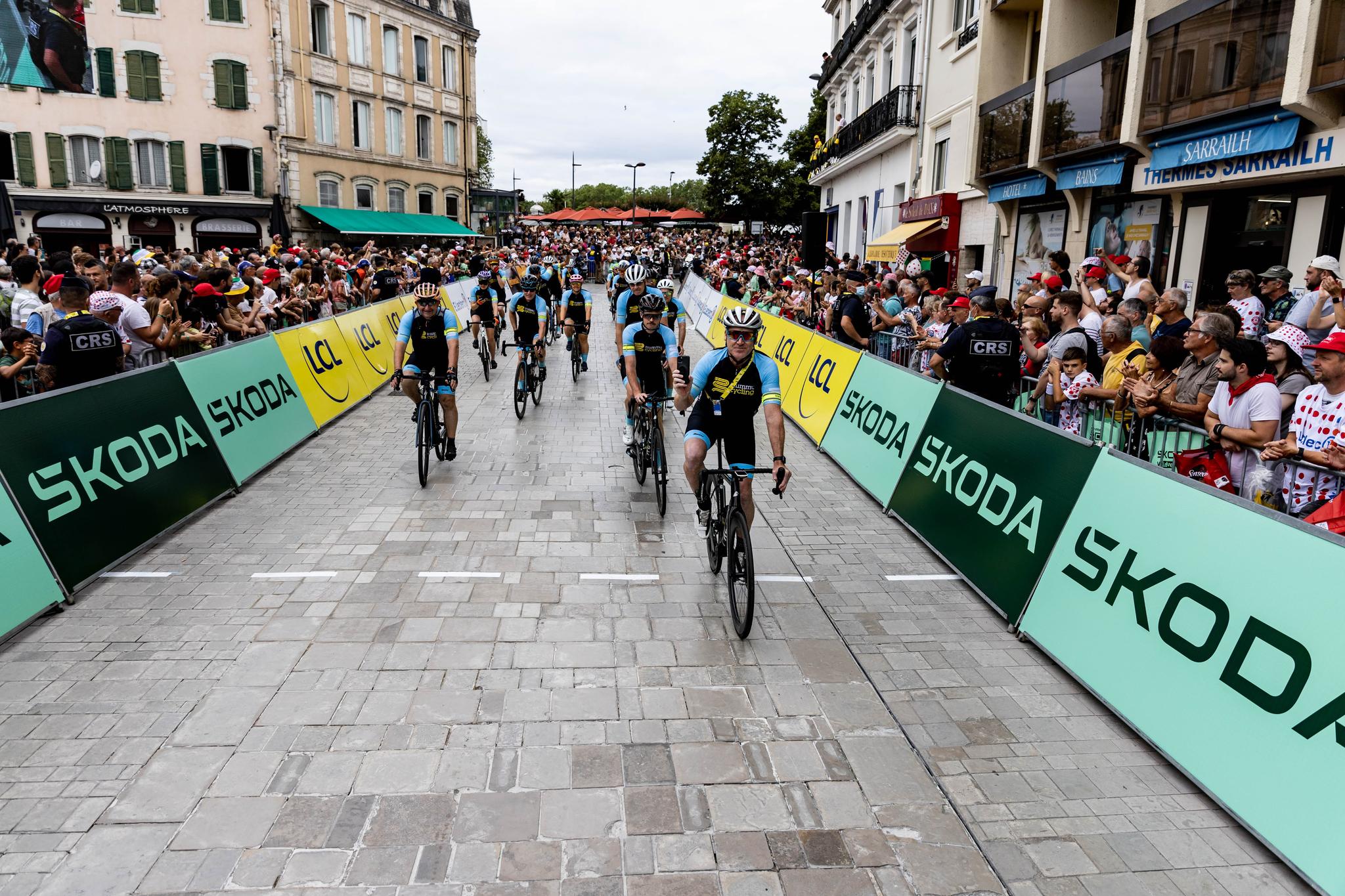Cyclists on cobblestone street, Tour de France Stage 4