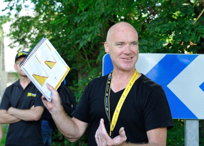 Man holding notebook with climb profiles