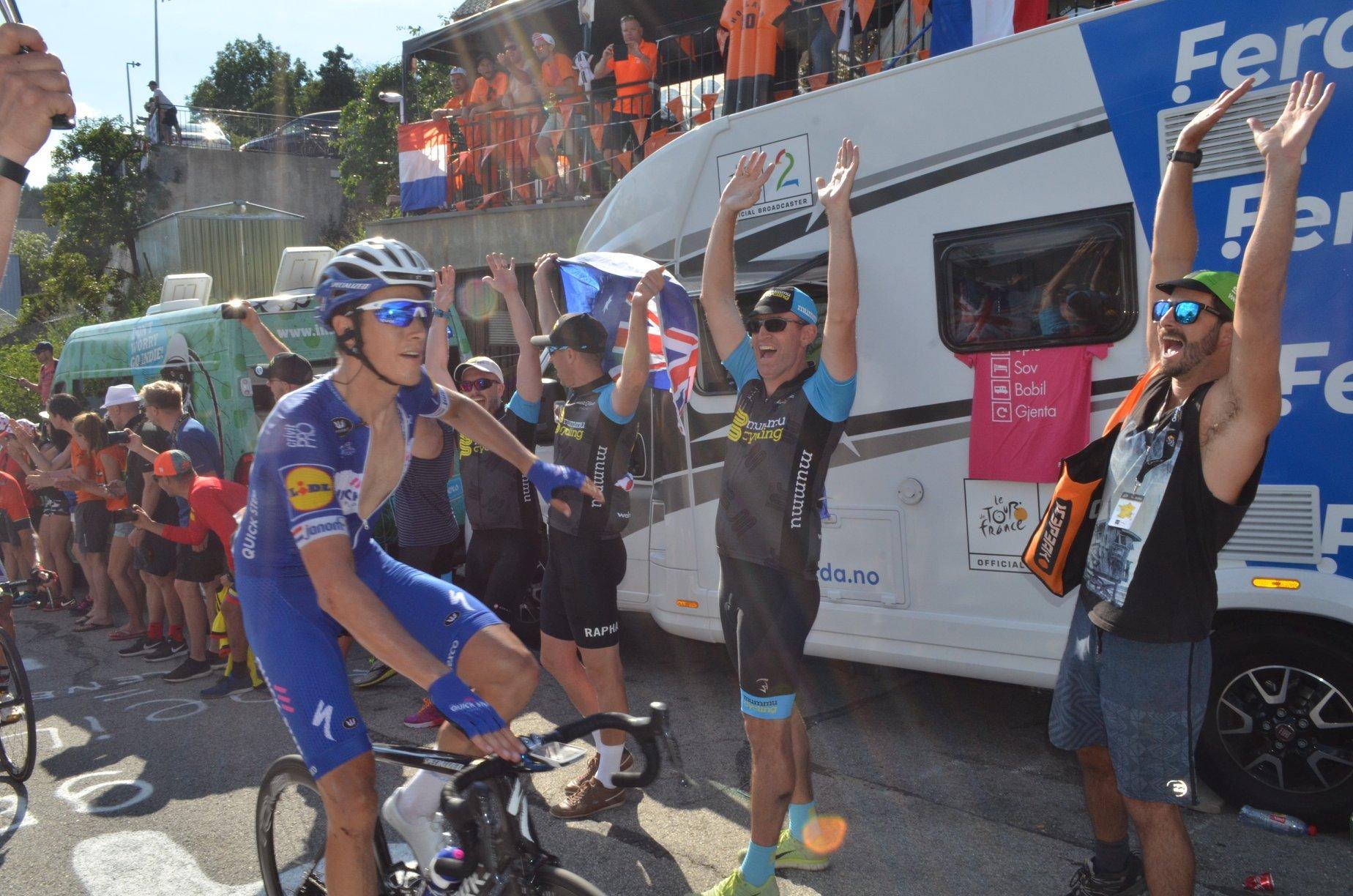 Cyclist in Soudal Quick-Step kit on Alpe d'Huez with Mummu Cycling supporters.