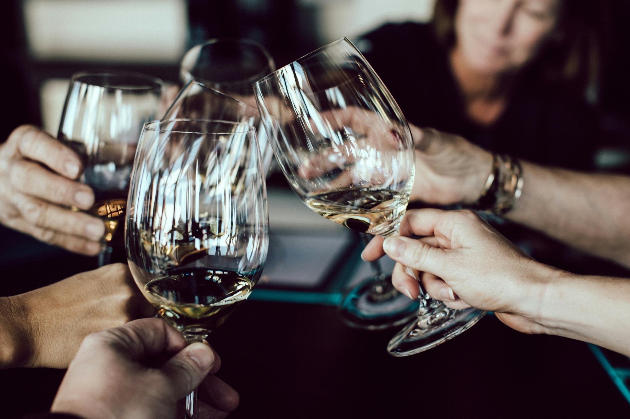 People toasting with wine glasses